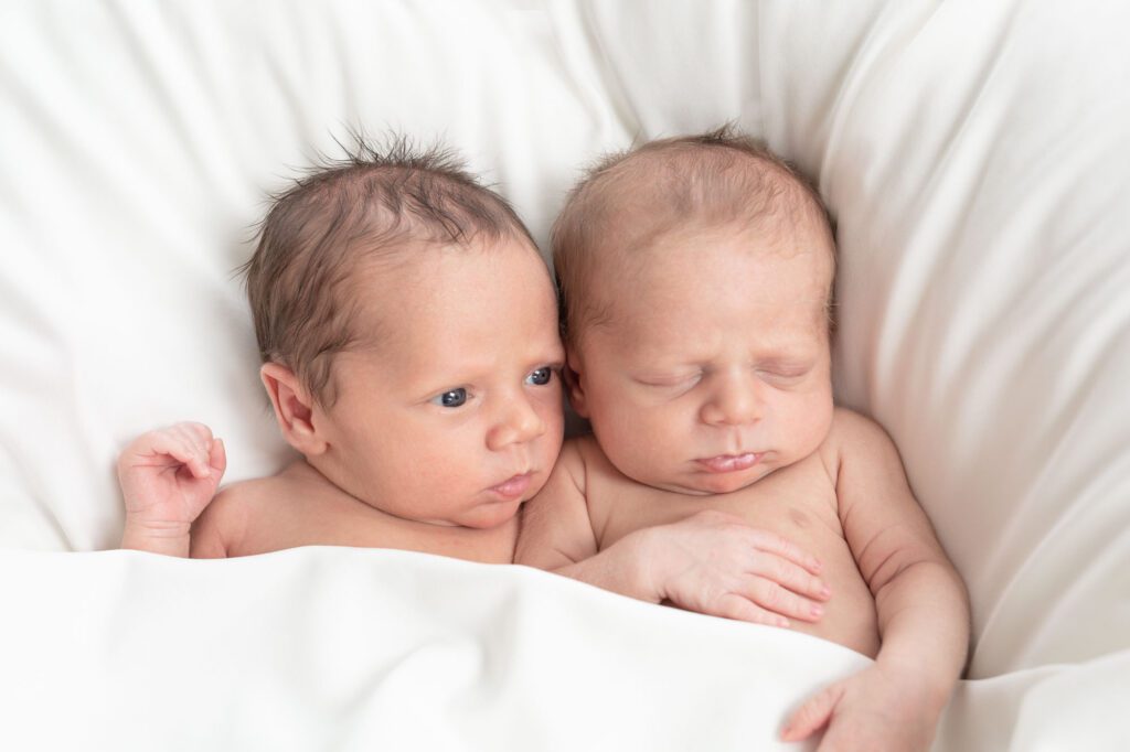 Newborn twin photos should show their personalities.